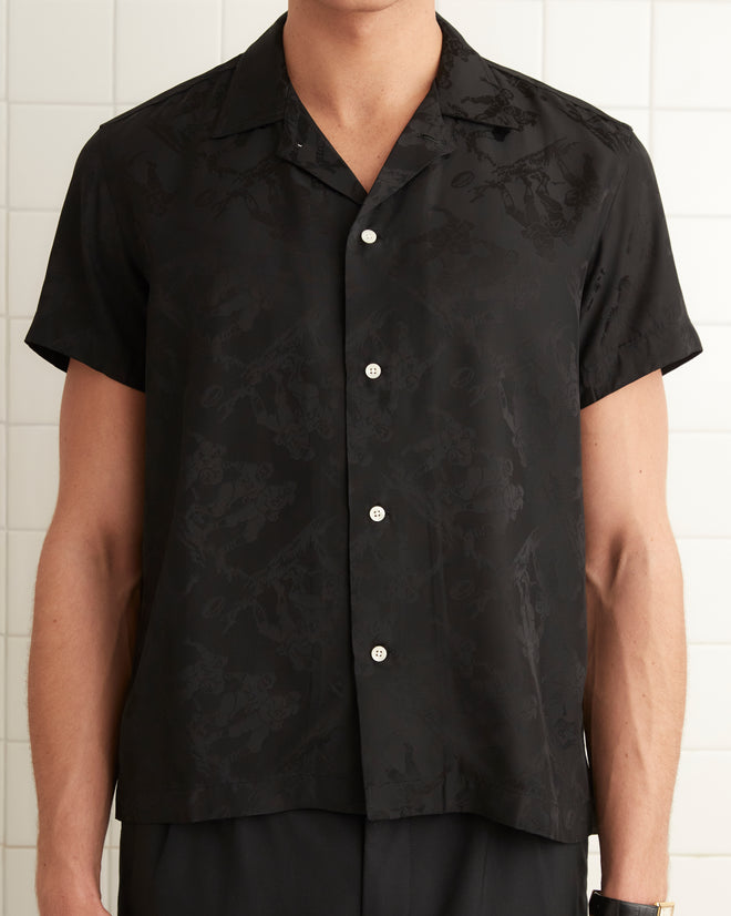 Black silk and viscose blend short sleeve shirt with football player jacquard print. Four button finish with pointed collar.