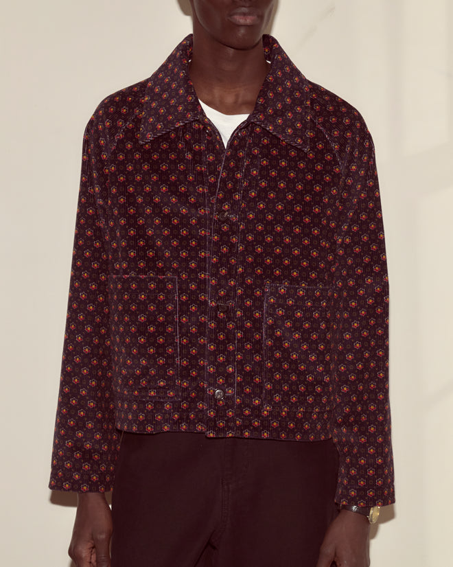 A person wearing the McAllister Corduroy Jacket with a subtle foulard pattern over a white shirt, standing against a light background.