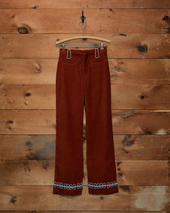 Cheval Corduroy Trousers in brown with Western detailing, light blue embroidery at the waist and cuffs.