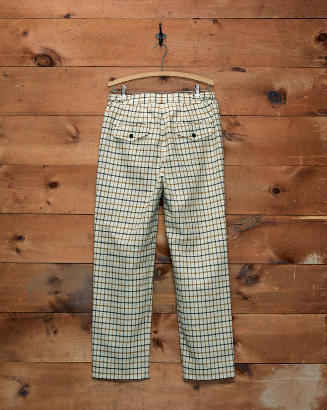 Back view of cream Sandhill Plaid Trousers with a dark brown and tan pattern, hanging on a wooden hanger.