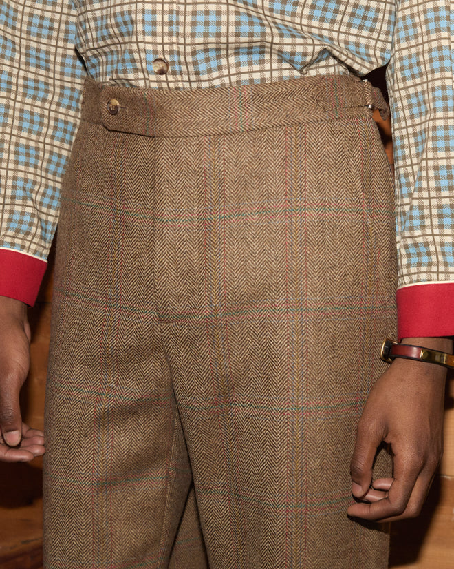Fremont Herringbone Trousers in brown tweed with a subtle plaid pattern and a classic silhouette.