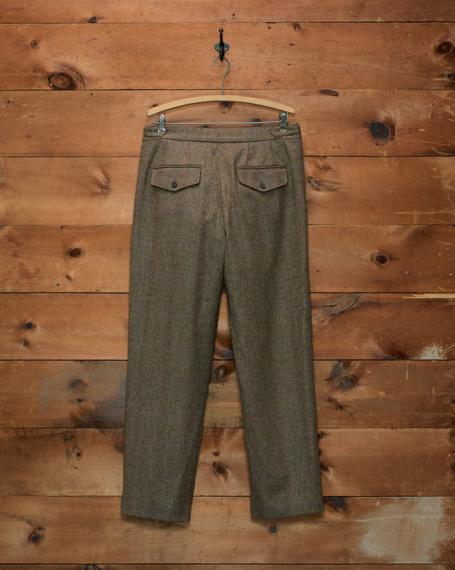 Back view of brown herringbone Fremont Herringbone Trousers with two buttoned flap pockets, on a wooden hanger.
