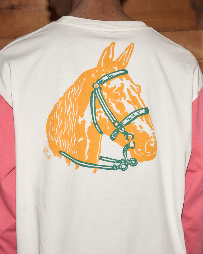Wearing the Checkers Baseball Tee, a 100% cotton bleached shirt, a person displays an orange horse head graphic with a green bridle on the back.