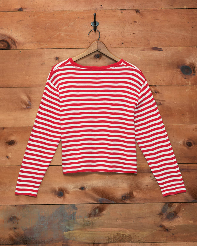 Rib Stripe Hayes Long Sleeve Tee in red and white stripes displayed on a wooden hanger against a wood wall—a nod to classic Western-movie sidekick style.