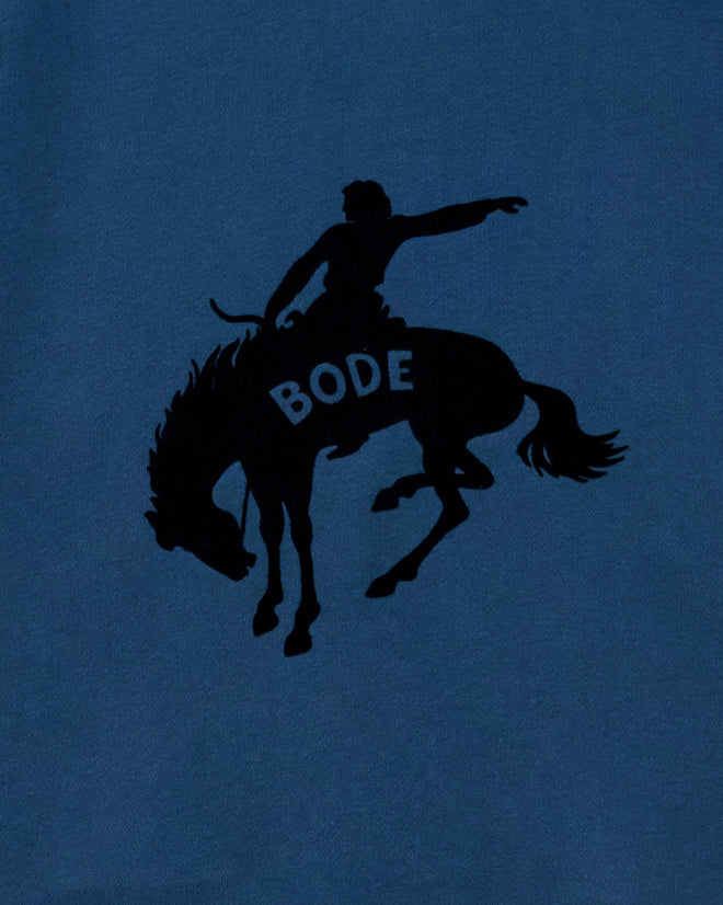 Roughrider Hoodie in blue wash with a black bucking rodeo rider silhouette and a cut-out neckline.
