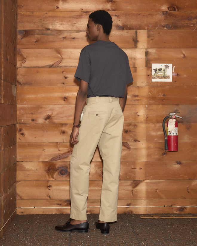 A person seen from behind wearing a dark grey t-shirt and khaki Campus Trousers.