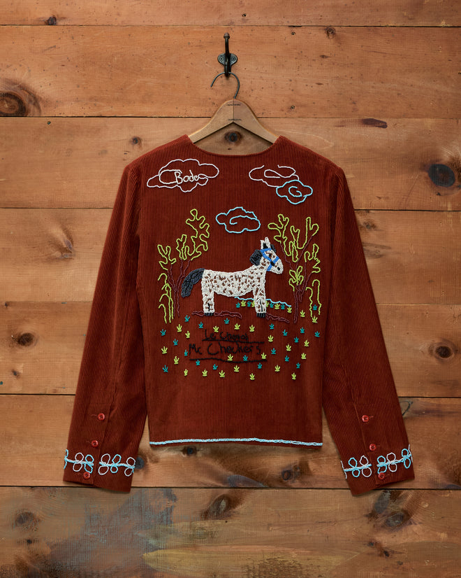 Brown corduroy Cheval Corduroy Jacket featuring a hand-beaded embroidered horse and landscape scene on the back.