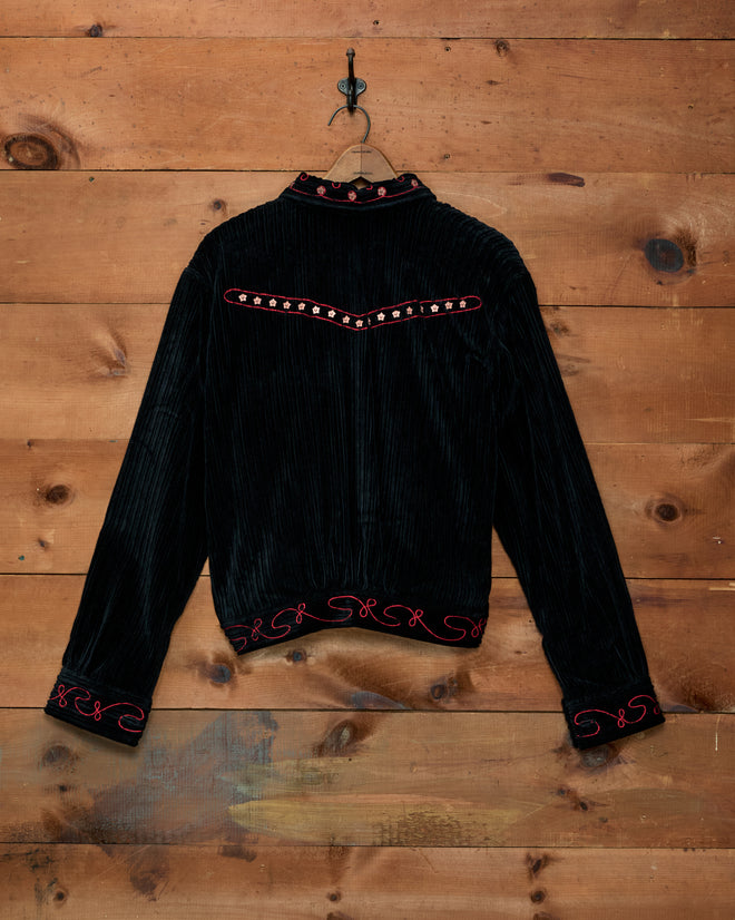 Black Corduroy Copper Spur Jacket with pink floral and scroll embroidery on the back and cuffs.