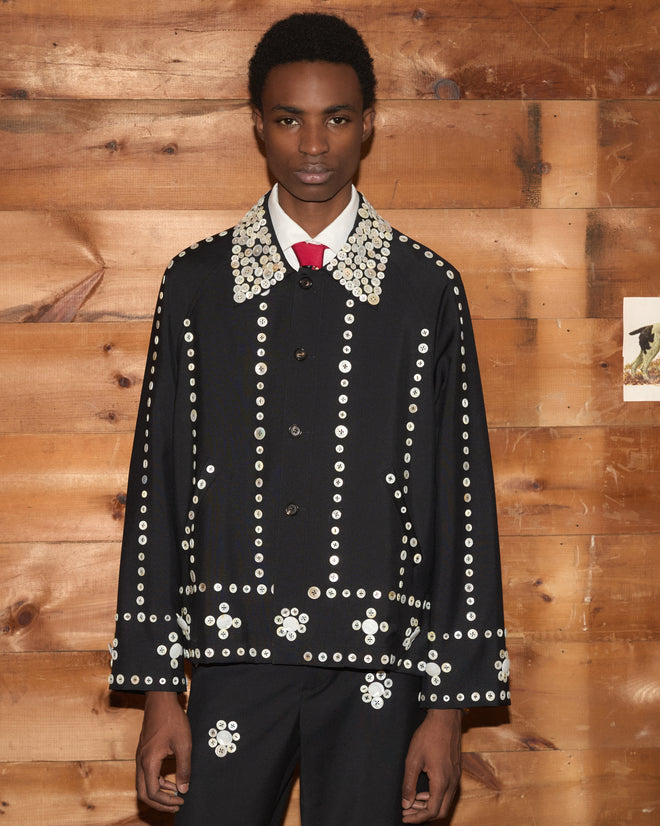 Pearly Royal Jacket, a black jacket covered in numerous antique-style white pearl buttons.