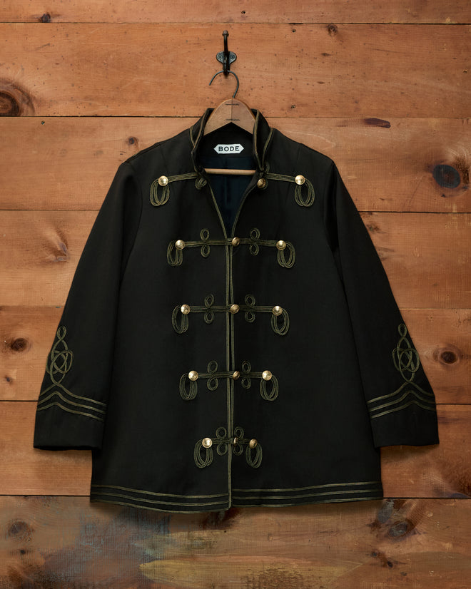 Cavalry Coat in black wool with gold braided toggles, soutache trim, and embroidery.