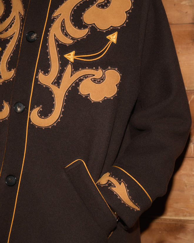 Ponderosa Appliqué Coat in dark brown wool with tan floral appliqué and piped trim.