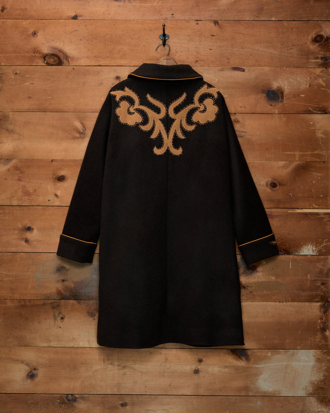 Ponderosa Appliqué Coat: black wool swing coat with tan floral appliqué on the back and tan trim on the collar and cuffs.
