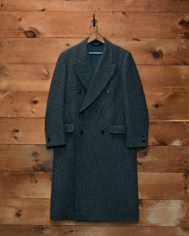 Buffalo Tweed Coat: double-breasted Donegal tweed wool coat with a herringbone pattern hanging on a wooden hanger.