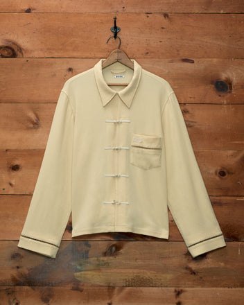 Ladder Crêpe Shirt in cream cotton with a pointed collar, toggle closures, and a single breast pocket.