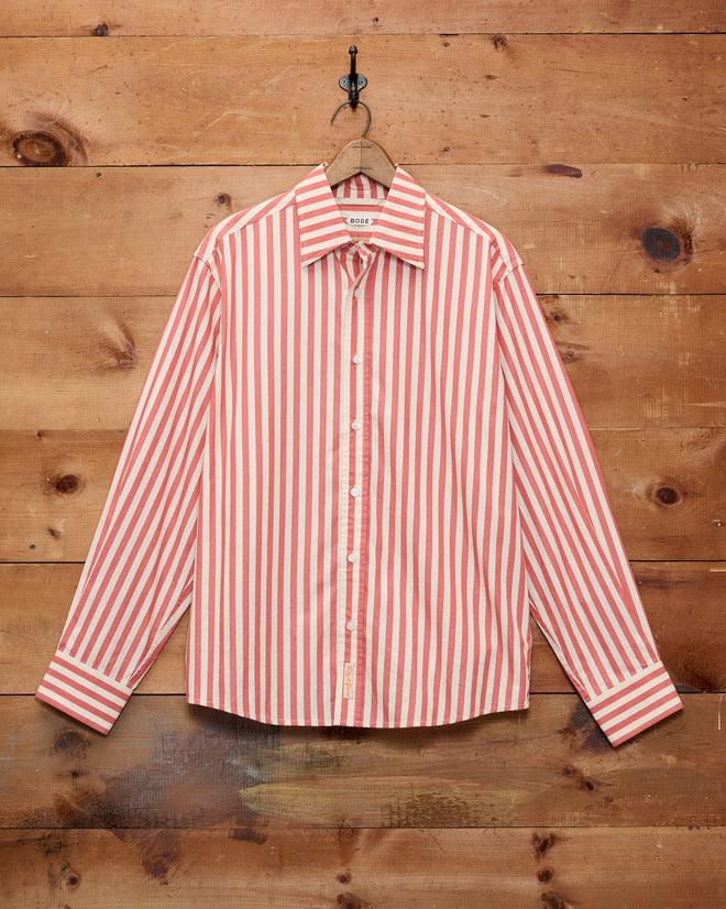 Rancho Long Sleeve Shirt in classic red and white vertical stripes, featuring a button-up design and displayed against a wooden wall. Crafted from 100% cotton and made in India, this shirt embodies timeless style and superior craftsmanship.