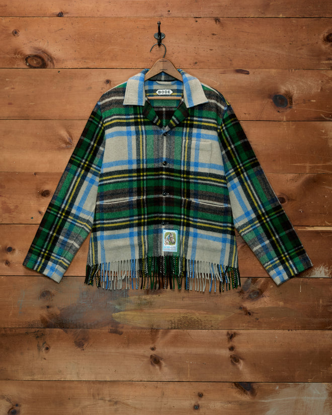 Mr. Checkers Overshirt in a blue, green, and cream plaid pattern with long sleeves, button-up front, and fringed hem.