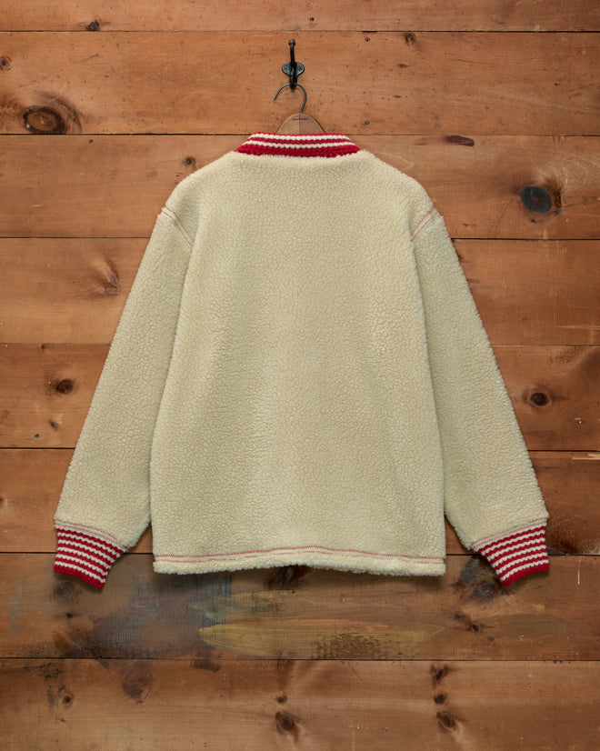 Woolly Warmup Jacket: cream-colored sherpa cardigan with red and white striped ribbed trim.