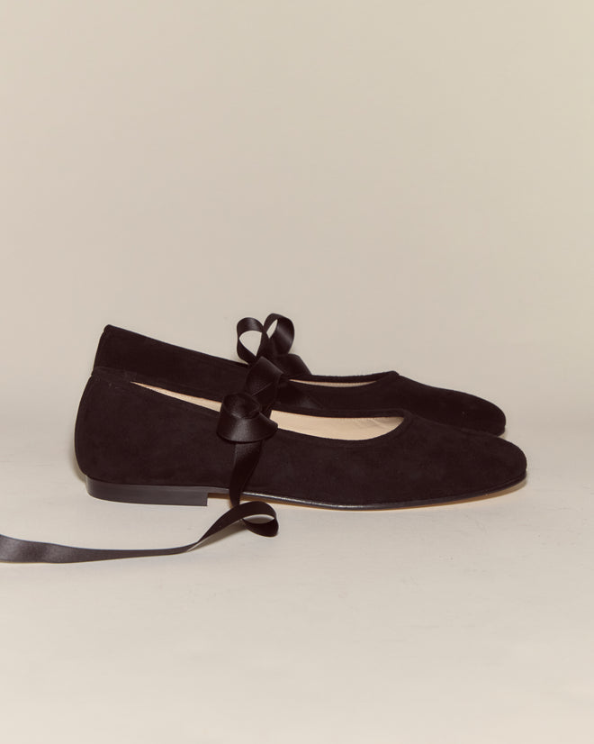 The Musette Flats - Black, crafted from suede with satin ribbons, are displayed side by side on a neutral background.