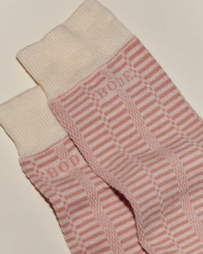 Micro Check Socks - Pink/Cream: A pair of pink and cream striped socks featuring "BODE" text near the top, inspired by vintage children's socks.