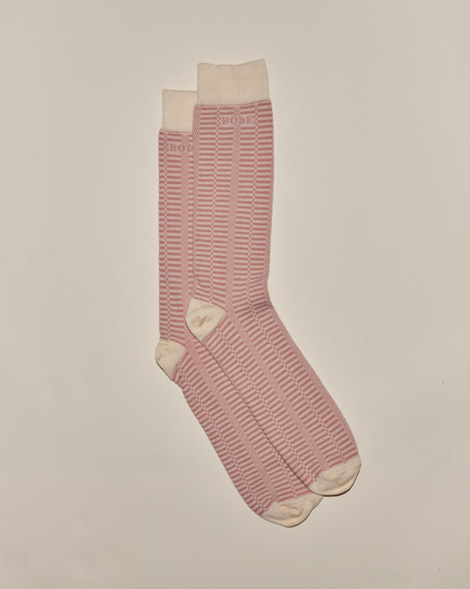 A pair of Micro Check Socks in pink and cream, featuring vintage-style stripes with cream cuffs, heels, and toes, laid flat on a plain background.