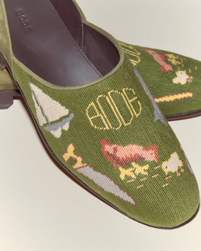 The Needlepoint House Shoes feature green embroidered needlepoint with nautical and animal motifs, "BODE" on the upper, and are expertly crafted in Italy. Inspired by the classic Bode House Shoe.