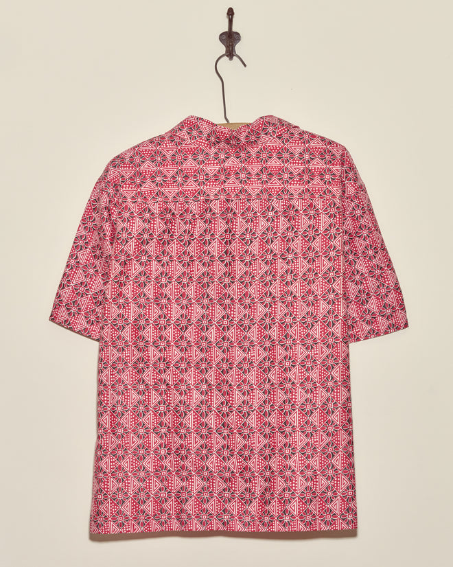 Organic Geometry Shirt - XXL in red and white with geometric patterns, short-sleeved and deadstock, displayed with the back facing forward on a wall hook.