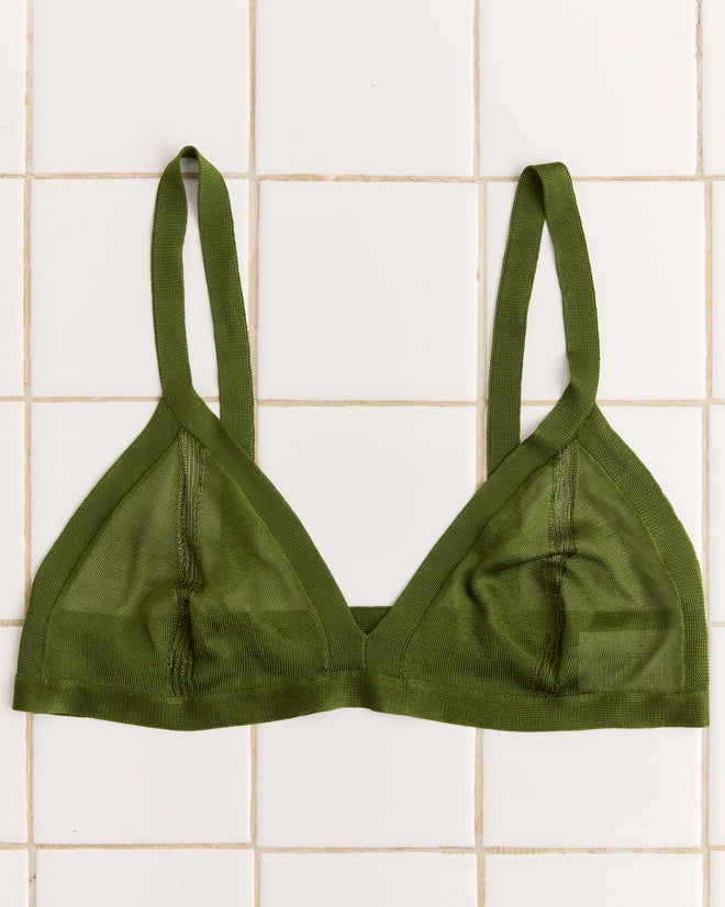 Apple green Knit Bra with thin straps, inspired by 1960s-1970s style, displayed flat on white square tiles.