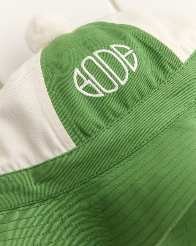 The "Paneled Grandfather Hat - Green/White" features expert embroidery of "GODE," topped with a small pom-pom.