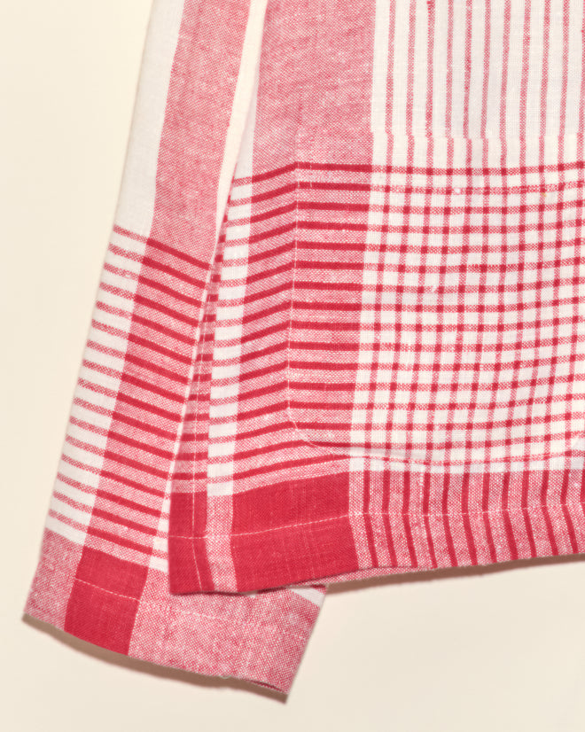 A neatly folded Park Stripe Long Sleeve Shirt - S in red and white checks with striped and plaid patterns on a light surface, reminiscent of a unique damask shirt.