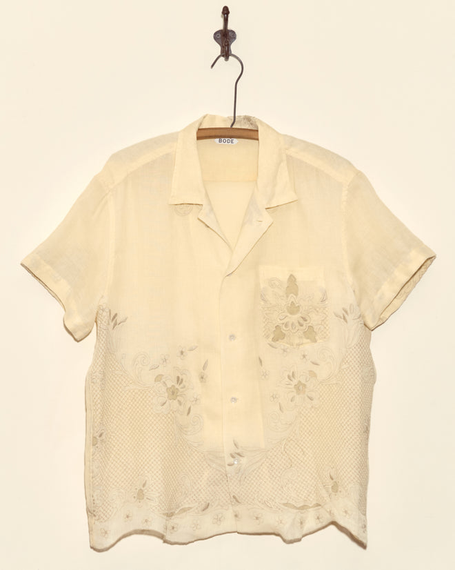 The Parquet Blossom Short Sleeve Shirt in cream, size L, features Madeira embroidery and hangs on a hanger against a plain background.