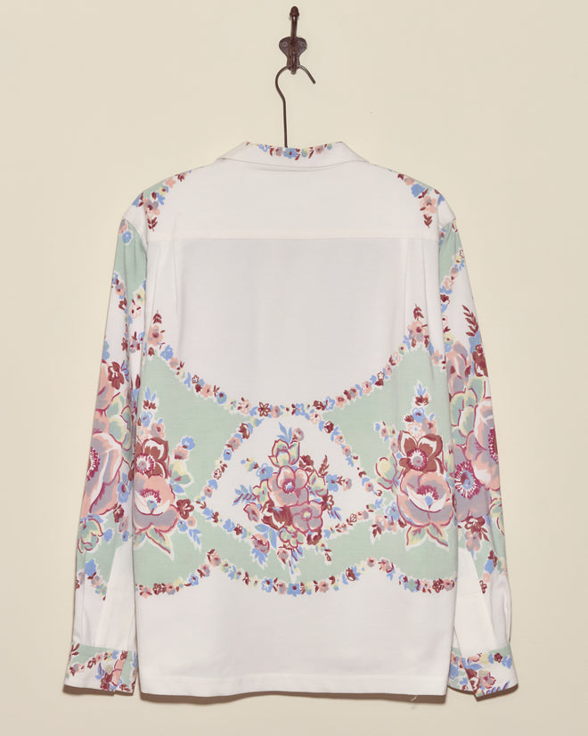 The Pastel Bouquet Long Sleeve Shirt - L/XL showcases pastel floral patterns on a white background, evoking vintage tablecloth charm, and looks stunning when hung on the wall.