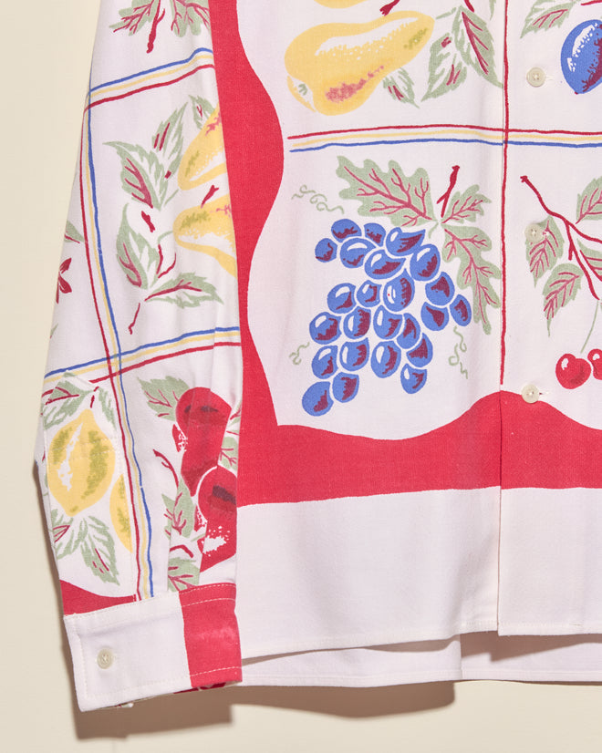 Introducing the Pineapple Glory Shirt (L/XL)—a unique, vintage-inspired shirt with a colorful pineapple print on a white and red background, reminiscent of a classic tablecloth style.