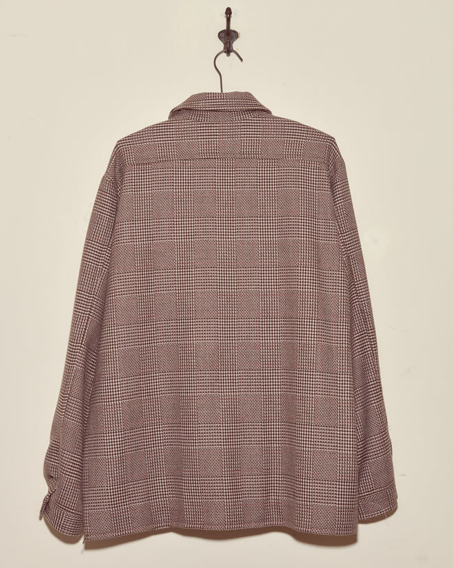 Unique Pink Granite Jacket in size L/XL, displayed on a hook against a plain beige wall, shown from the back.