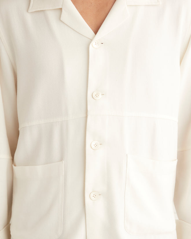 White cotton viscose blend long sleeve shirt with tonal fabric blocking on piece. This shirt features two large pockets at front hips.