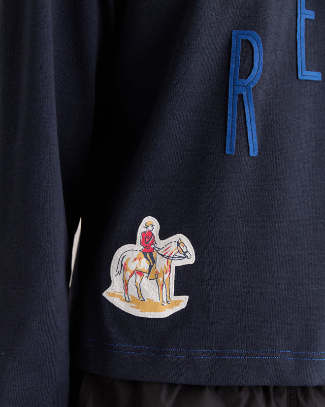 The Rec Pullover - Navy showcases a cowboy on horseback patch with partial blue lettering above, made from heavyweight fabric for enhanced durability.
