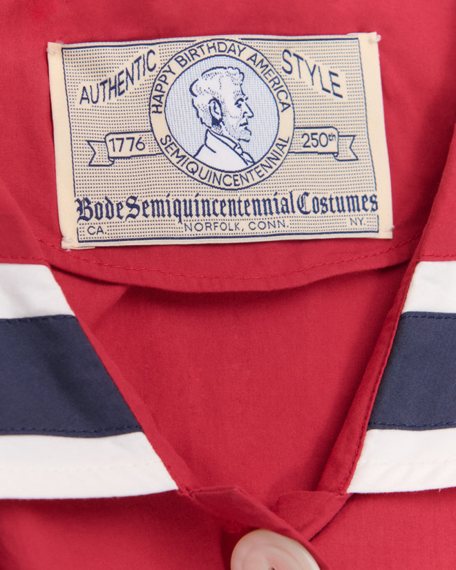 Closeup of a vintage "Authentic Style" Centennial Blouse label on a red garment, inspired by antique Liberty blouse designs—perfect for celebrating America’s 250th birthday and the Fourth of July.
