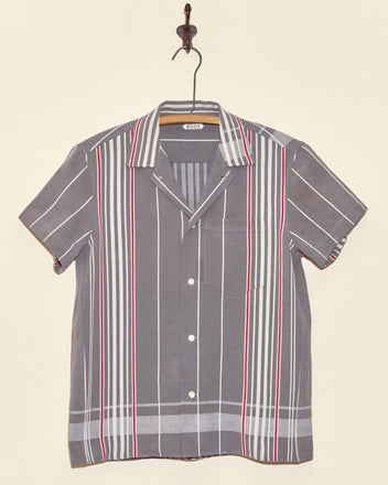 Rock Dove Short Sleeve Shirt - XS: Vintage gray button-up with white and red vertical stripes, made from antique ticking fabric. Displayed on a hook against a beige wall.