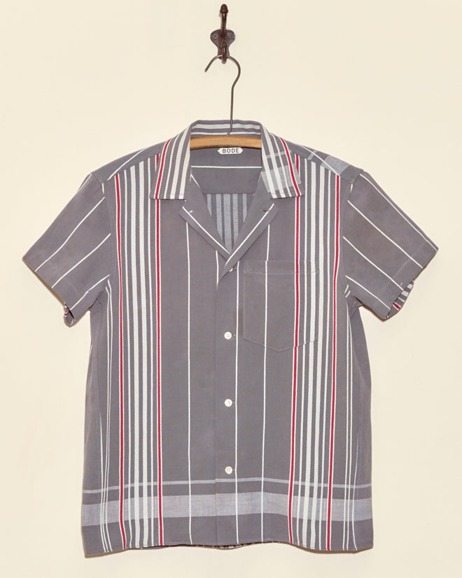 Rock Dove Short Sleeve Shirt - XS: Vintage gray button-up with white and red vertical stripes, made from antique ticking fabric. Displayed on a hook against a beige wall.