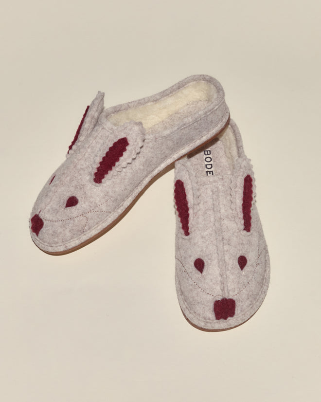 Two cozy Rabbit Slippers - Cream Red, featuring a bunny face with maroon ears and nose on a light gray background.