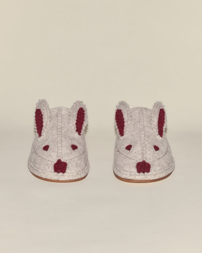 Pair of felt house slippers called "Rabbit Slipper," designed to resemble rabbits with ear and nose details, displayed on a plain background.