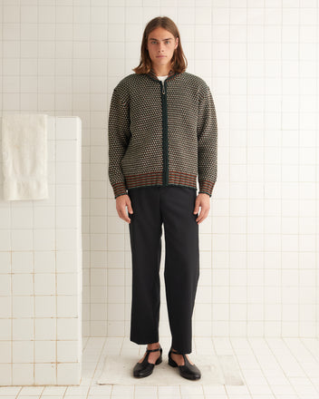 Green, white, rust orange merino wool collared sweater with a ball-chain zipper and ribbed detailing around the collar, cuffs, and hem.