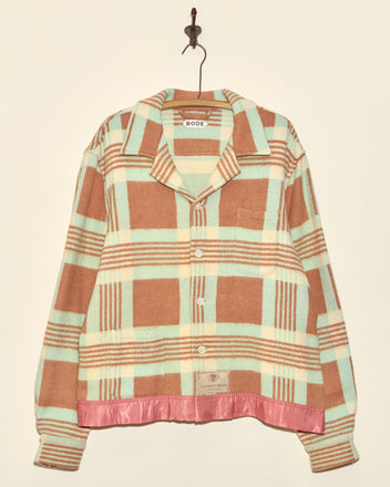 The Seafoam Plaid Jacket - XXL features brown, mint, and cream plaid with a pink satin hem. This unique, one-of-a-kind piece is made in New York and hangs stylishly on a hook.