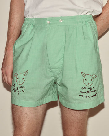 Person wears See You at the Barn Boxers in mint green, showcasing hand-beaded sheep faces and handwritten text on each leg.
