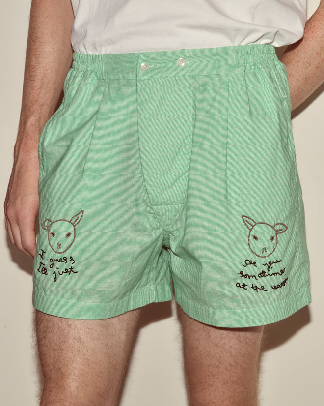 Person wears See You at the Barn Boxers in mint green, showcasing hand-beaded sheep faces and handwritten text on each leg.