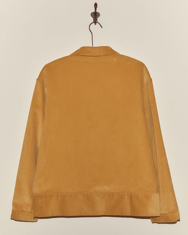 Mustard yellow Custom Senior Cord Side Tab Jacket hangs on a hook, shown from the back against a plain wall—a timeless style in classic corduroy.