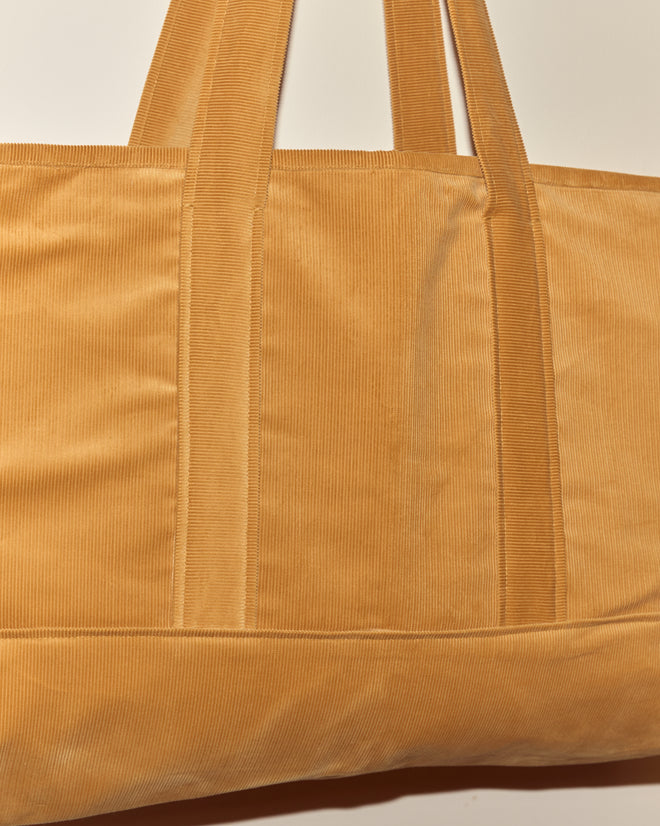 Close-up of a tan Custom Large Senior Cord Tote with wide handles against a neutral background, perfect for carrying your custom corduroy notebooks.