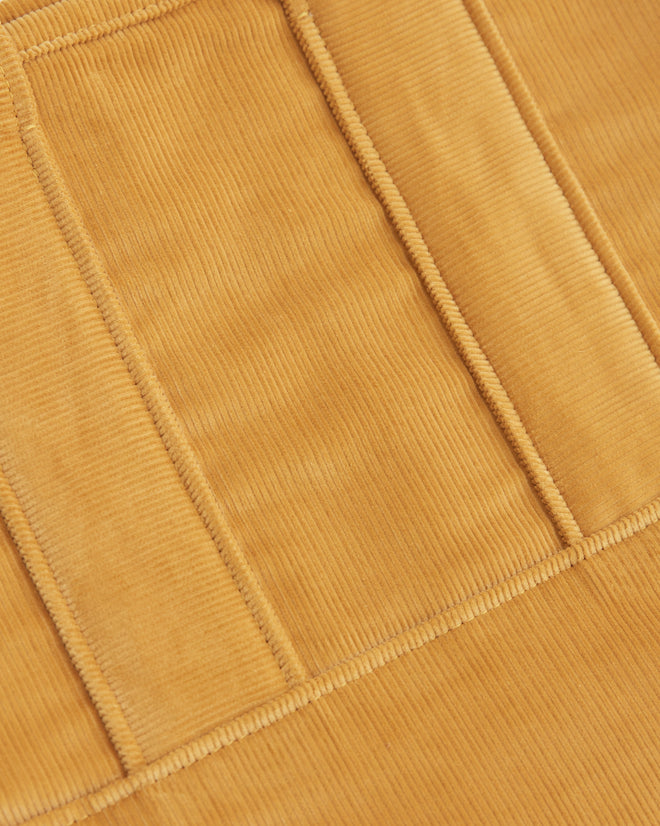 A Custom Small Senior Cord Tote in mustard yellow, made from British corduroy and featuring long handles, displayed against a white tile background.