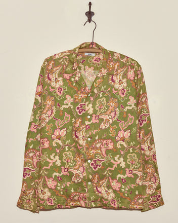 Smoke Moss Shirt - M/L: Green long-sleeve vintage shirt with a colorful floral and paisley pattern, displayed hanging on a hook against a plain wall.