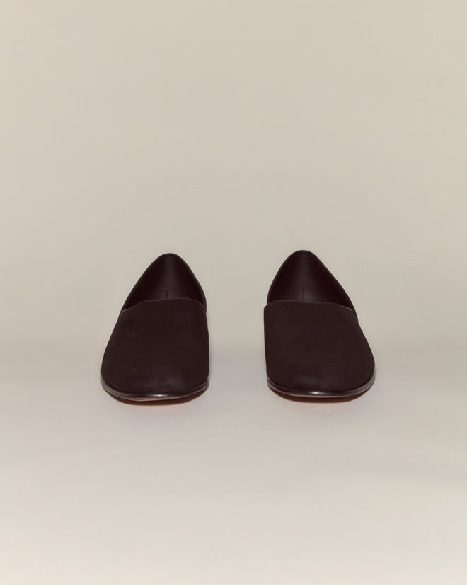 A pair of Suede House Shoes - Black, crafted in Italian suede with a leather sole and slip-on design, shown against a light background.