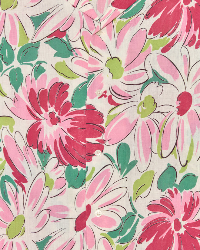 The Sukhothai Flower Shirt is a unique piece, showcasing floral fabric with bold pink, red, and green flowers and detailed with classic white center buttons.